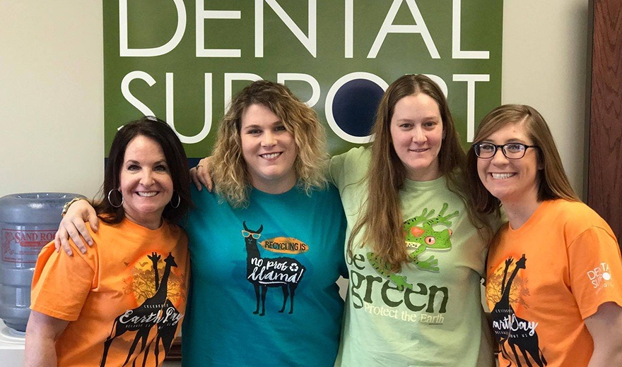 Team members wearing different earth day shirts