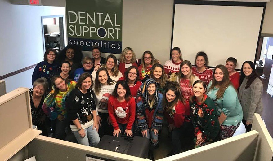 Team members wearing Christmas sweaters