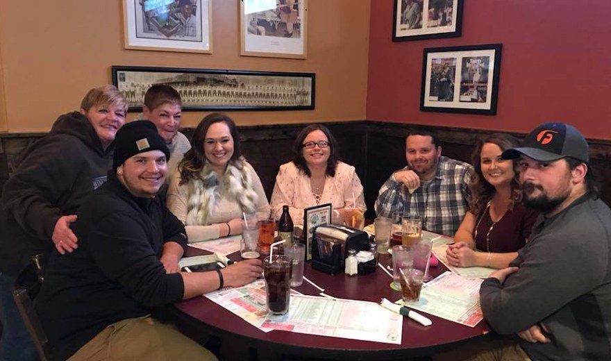 Team members sitting in a booth together