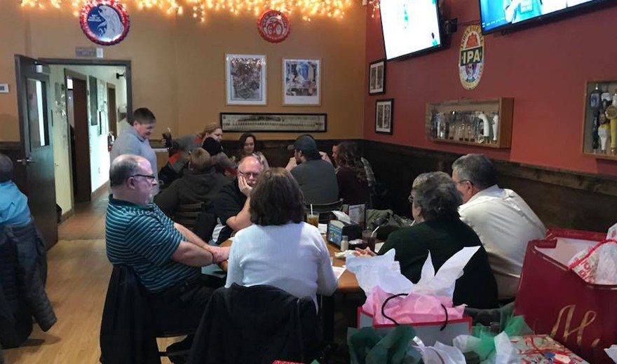 Team members sitting at several tables together in a restaurant