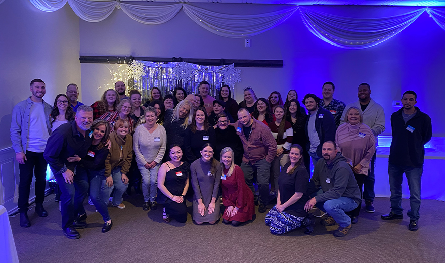 Team members taking a photo at a community event