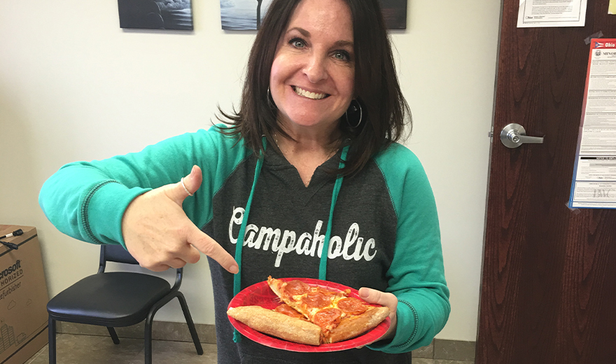 Team member eating pizza