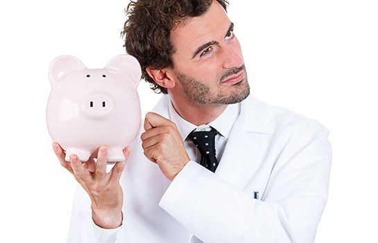 dentist listening for money in a piggy bank