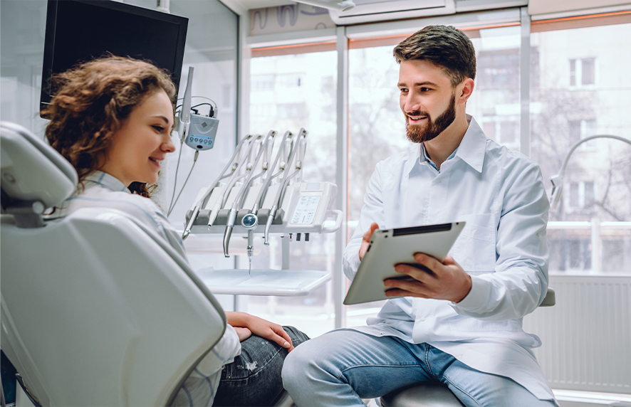 Dentist talking to dental patient