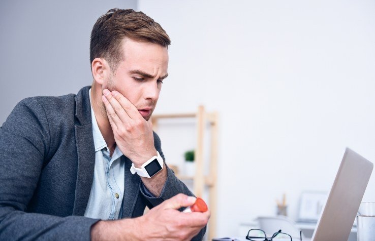 stressed dental team member taking medication