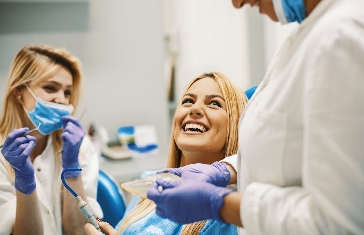 Dental patient laughing with dental hygienists