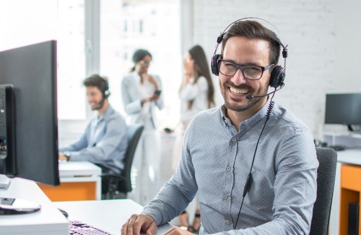 Friendly team member with phone headset on