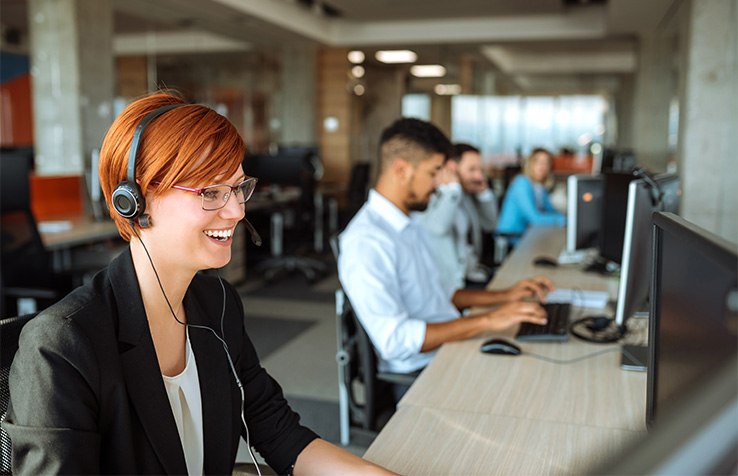 Smiling person wearing a headset in an office