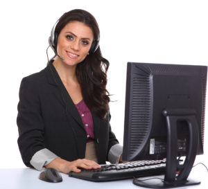 Smiling woman with computer and phone headset