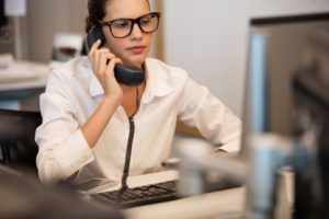 A woman on the phone at her job.