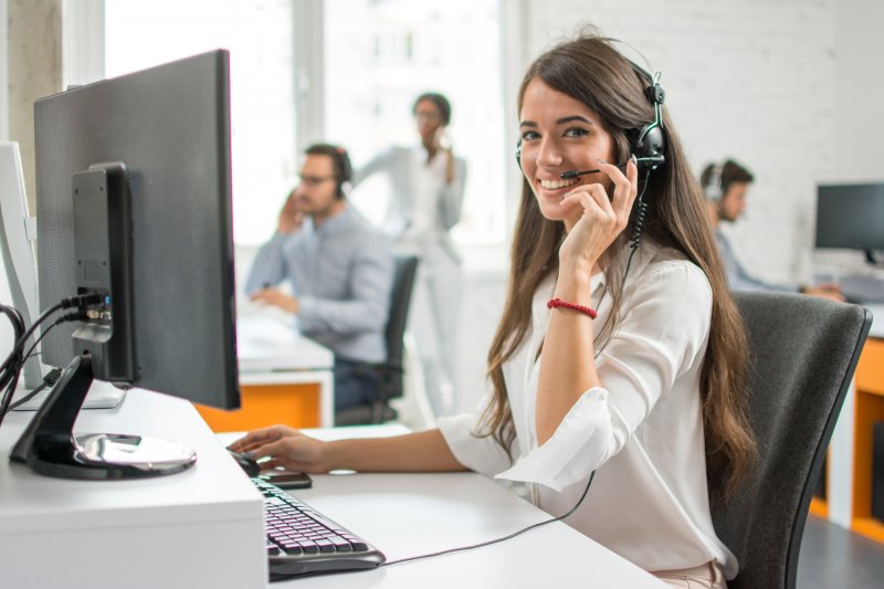 A woman answering the phone in a call center.