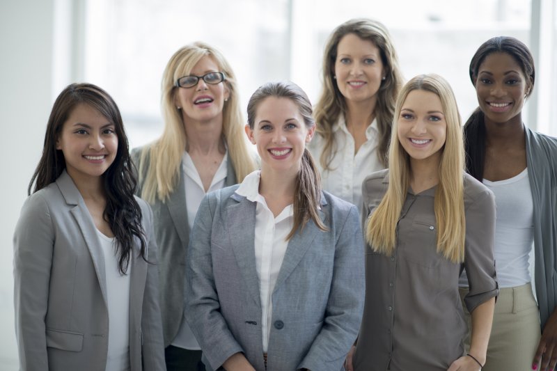 A group of businesswomen smiling.