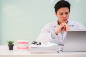 dentist working on laptop