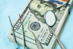 money, dental tools, and dental insurance verification