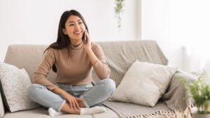 smiling woman talking on phone with scheduling support