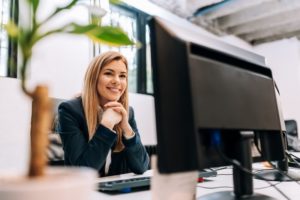 happy front desk worker working with dental answering service