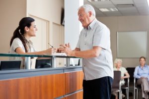 happy receptionist helping a patient