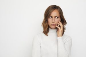 woman on the phone who looks frustrated