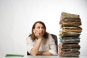 woman looking at a stack and needing dental insurance support