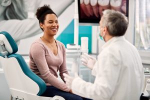 happy patient talking with the dentist after using dental answering service