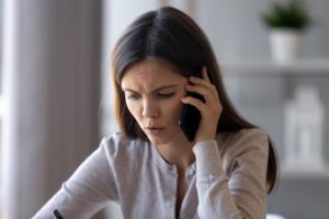 woman who is frustrated dealing with a normal dental answering service