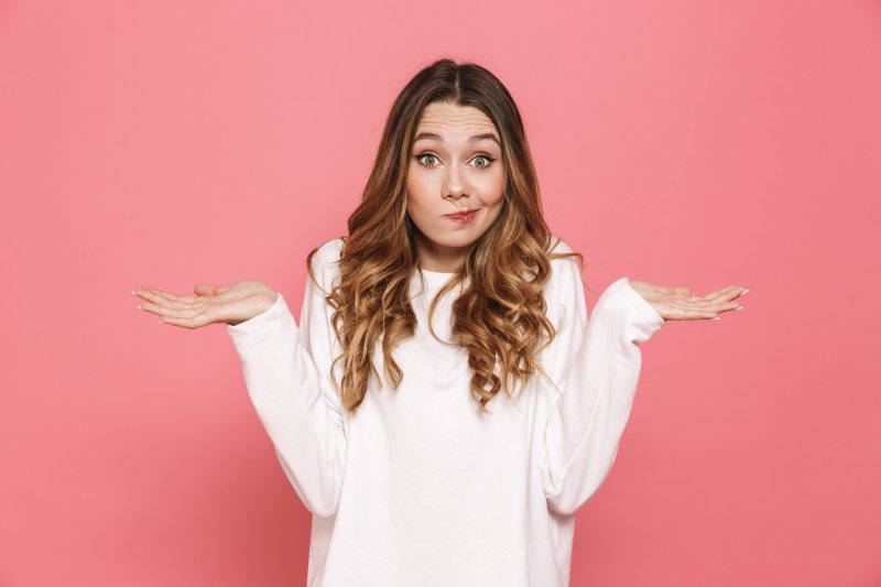 woman trying to make a decision about a dental answering service