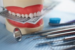 instruments, money, and teeth indicating dental billing