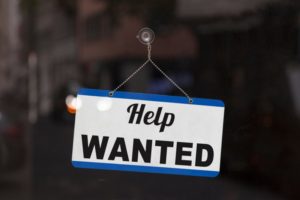 help wanted sign showing staffing struggles