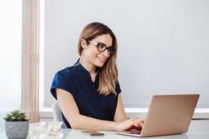 person searching for dental billing service on a computer