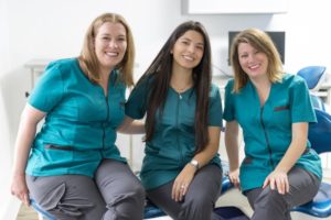 happy dental team showing good dental staffing