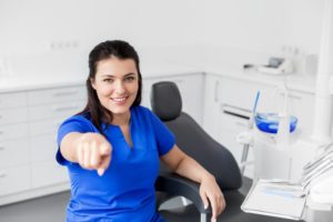 female dentist in an operatory pointing 