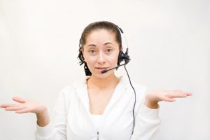 woman with a headset looking confused