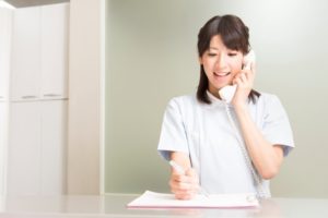 front desk receptionist talking on the phone