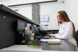 busy front desk team member with work