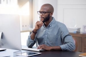 man thinking of a solution to dental insurance billing problems