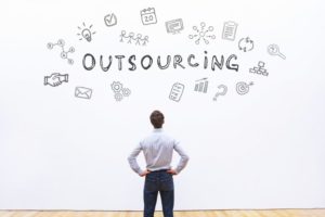 person with words and images above his head about outsourcing