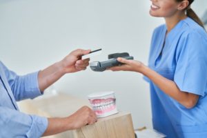 dental professional getting payment from a patient