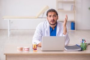 stressed dentist at a computer