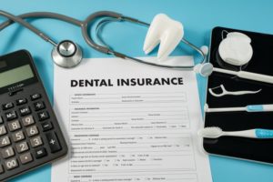 dental insurance claim form surrounded by dental and medical tools