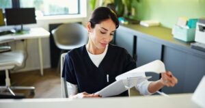 front desk staff member looking at paperwork
