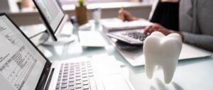 tooth hovering over a computer keyboard for dental billing