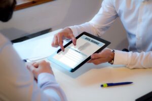 dentist showing a tablet with insurance on it