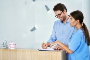 patient paying for dental treatment after conversation