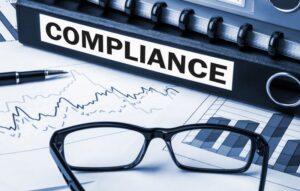 compliance paperwork with check marks above it